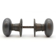 an old metal door handle with two knobs on each side and one in the middle