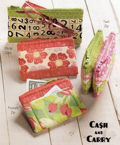 four small wallets are sitting on the floor with their numbers printed onto them and labeled cash and carry