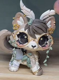 a small figurine with glasses on it's head and an angel outfit