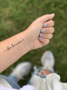 a woman's arm with a small tattoo on it that says, love is in the air