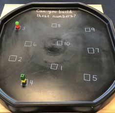 a black board with numbers and dices on it that says can you build these numbers?