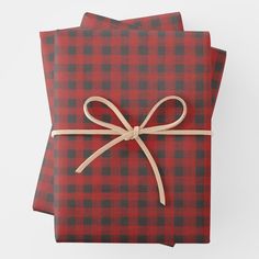 two red and green plaid napkins with mickey mouse designs on them, tied together