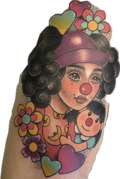 a woman with a clown nose and hat on her arm holding a child in her arms