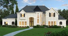 a large white house with lots of windows on it's front porch and landscaping