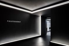 an empty room with black walls and white lettering on the wall that reads masterminda