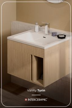 a bathroom sink sitting under a mirror next to a wall mounted toilet paper dispenser