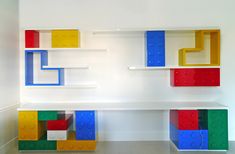 two shelves made out of legos in a room with white walls and flooring