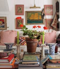 a living room filled with lots of furniture and flowers on top of a coffee table