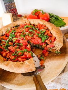 a pizza with tomatoes and basil on top