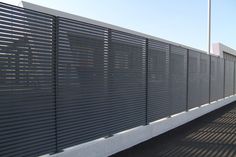 a black fence with horizontal slats on it