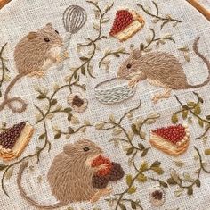 a cross stitch pattern with mice and berries on it