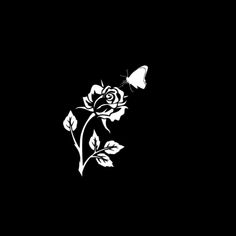 a black and white image of a rose with a butterfly on it's back