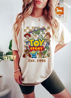 a woman wearing a toy story t - shirt