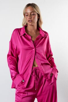 Elevate your style with the Color Pop Button Down features a collared neckline, button down front and long button cuff sleeve. Worn with the matching Color Burst Satin Pant. Color: Pink Satin Fabrication Button Down Front Collared Long Button Cuff Sleeve 94% Polyester / 6% Spandex Model is 5'7", 32A Bust, 26 Waist & Wearing Size Large Fit Recommendations: Size Up For More Oversized Look Chic Single-breasted Long Sleeve Sets, Spring Button-up Sets With Buttons, Collared Loungewear Sets With Buttons, Long Sleeve Loungewear Sets With Button Closure, Collared Sets With Buttons For Loungewear, Collared Shirt With Buttons For Loungewear, Pink Button-up Blouse For Loungewear, Chic Button-up Sets, Chic Button-up Set With Details