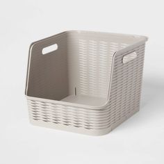 a large white basket with handles on the front and bottom, sitting against a white background