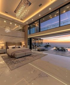 a large bedroom with an ocean view is shown in this image, the room has white marble floors and walls