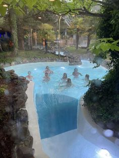 several people are swimming in an artificial pool