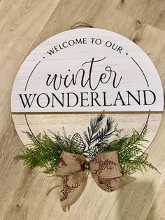 a wooden sign that says, welcome to our winter wonderland on the side of a wood floor