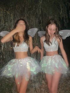 two girls dressed in fairy costumes standing next to each other