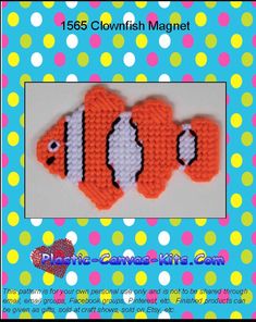 an orange and white crocheted clown fish on a blue background with polka dots