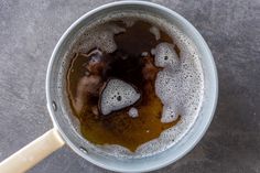 a cup filled with liquid sitting on top of a table