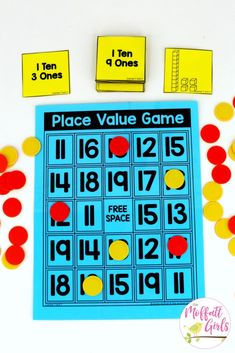 a place value game is shown with red, yellow and blue circles on the table