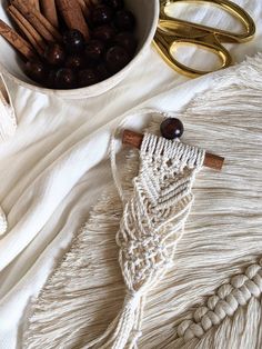 a white bowl filled with cinnamons next to scissors and other crafting supplies on top of a table