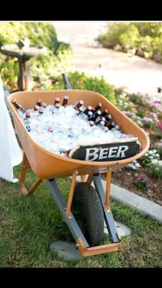 a wheelbarrow filled with bottles of beer