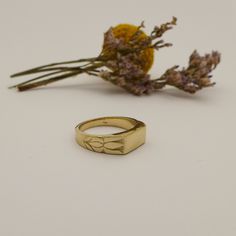 Unique Engraved 14K / 18K Solid Gold Signet Ring for Men and Women Handmade of Yellow / White / Rose Gold. Shaped as a classic rectangle signet ring with simple straight edges and engraved with two lotus flowers blooming on the sides of the ring. It has a simple straight rectangle shape held and embraced by two flowers. This ring is very unique and has a strong presence, it captures a flowing pattern within a geometric frame. It is made by hand out of wax inspired by the endless beauty of nature Heirloom Rectangular Signet Ring Stamped 14k, Luxury 14k Gold Rectangular Signet Ring, Rectangular 14k Stamped Rings For Gifts, Heirloom Yellow Gold Signet Ring In Recycled Gold, Heirloom 14k Gold Rectangular Ring, Heirloom Rectangular 14k Gold Rings, Modern Gold Rings With Engraving Option, Rectangular Diamond Cut Signet Ring For Anniversary, Yellow Gold Engraved Rectangular Ring