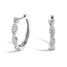 Twisted Vine Diamond Hoop Earrings - 18K White Gold. These stylish and eye-catching earrings feature dazzling round diamonds prong-set in twisting vines of lustrous, precious metal (1/6 total carat weight).