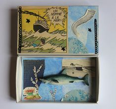 two matchboxes with pictures of fish and sea creatures in them, one is empty