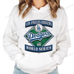 a woman wearing a los angeles dodgers hoodie with the word world series on it