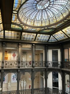 the inside of a building with many windows and balconies on each floor, as well as a skylight