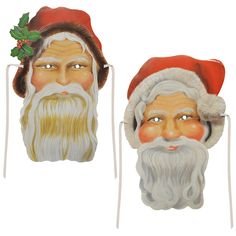 two santa claus masks with holly berries on their heads, one wearing a red hat and the other white beard