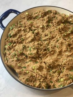 a pan filled with food sitting on top of a table