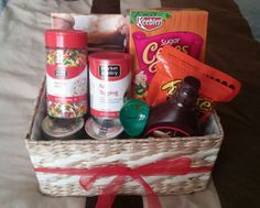 a basket filled with food on top of a bed next to a bag of candy