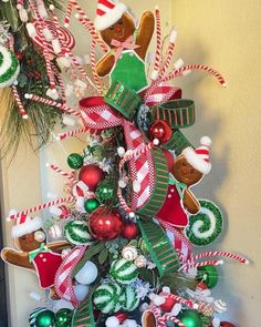 a christmas tree decorated with gingerbreads, candy canes and other holiday decorations