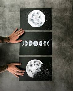 two hands are holding up three pieces of paper with the moon and stars on them