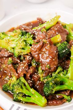 beef and broccoli with sesame seeds in a bowl