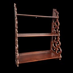 an ornate wooden shelf with three shelves