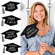 a woman in graduation cap and gown holding up some signs