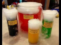 three different colored drinks are sitting next to each other on a table with labels reading vampire tonic and zombie juice