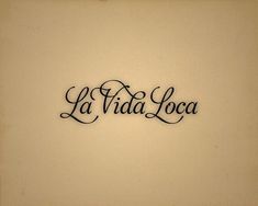 the word la vaa loca written in cursive writing on a wall