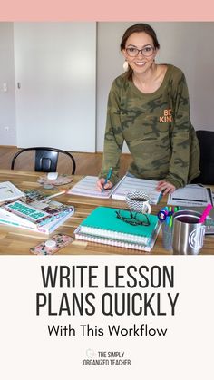 a woman sitting at a table with books and notebooks in front of her, writing lesson plans quickly