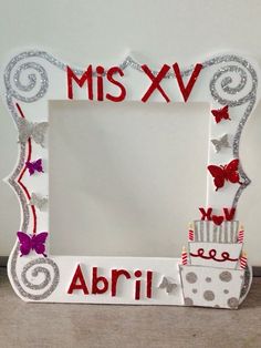 a white frame with red and silver decorations on it that says, miss xxv