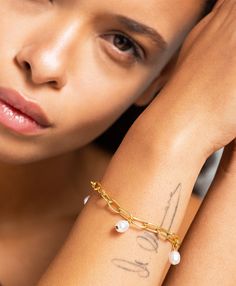 Delicate and demure, the Liva bracelet features a paper clip chain dotted with dainty freshwater pearl droplets, a versatile piece that will upgrade any outfit. Material: 18ct Gold Plated Brass with 1cm freshwater pearl detailing. Dimensions Chain Length 20cm White Pearl Bracelet With Delicate Chain, Dainty Pearl Drop Chain Bracelet, Adjustable Chain Pearl Bracelet, Minimalist Pearl Bracelet With Pearl Charm, Delicate Pearl Bracelet With Chain, Modern Mom, Branded Gifts, Trombone, Earrings Collection