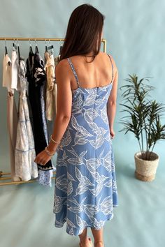 Slip into effortless style with our Light Blue Botanical Print Dress! The silky material and adjustable straps provide a comfortable fit while the deep v-neck and midi length add a touch of sophistication. This dress offers a playful twist on a classic floral design. Model is wearing a size small. Stocked at Arlington Village. V-neck Midi Dress With Tie Straps For Vacation, Blue Midi Dress With Tie Straps For Day Out, Beach Midi Dress With Adjustable Straps And V-neck, Sundress Midi Dress With Adjustable Straps And V-neck, Blue Summer Midi Dress With Tie Straps, Breezy Midi Dress With Spaghetti Straps, Blue Midi Dress With Tie Straps For Vacation, V-neck Midi Dress With Tie Straps For Day Out, V-neck Midi Dress With Adjustable Straps For Day Out