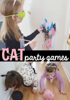 two girls playing with cat party games on the floor and in front of them are cats