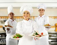 three chefs holding plates of food in front of a restaurant sign that says kurba catering