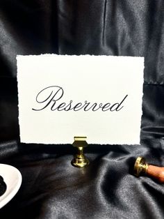 a sign that says reserved on it next to some food